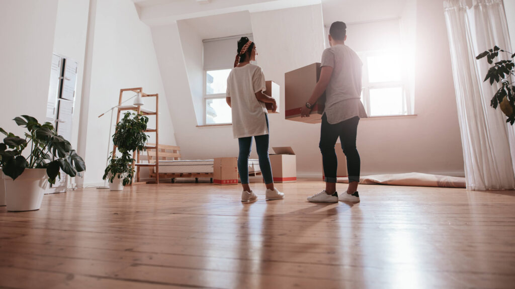 Couple holding boxes while moving into their Long Beach rental property.
